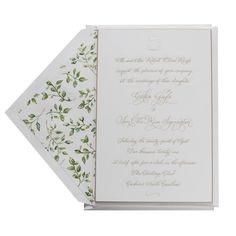 an elegant wedding card with green leaves on it