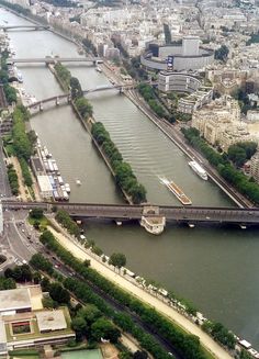 an aerial view of a river and bridge in the middle of paris, with lots of traffic on it