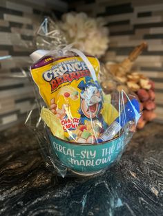 a basket filled with cereal sitting on top of a counter next to other food items