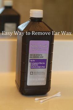 a bottle of homemade ear wax sitting on a counter top next to toothbrushes