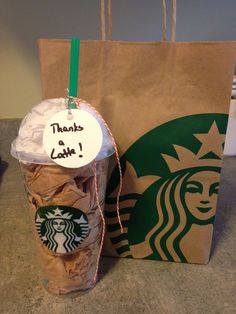 there is a starbucks bag with cookies in it and a paper bag that says thanks to coffee