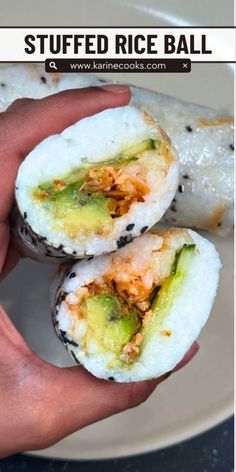 someone holding two sushi rolls in their hand with the text, stuffed rice ball