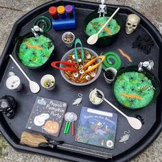 a tray filled with lots of halloween treats and other items on top of the tray