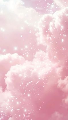 there is a pink sky with white clouds and stars in the sky on top of it