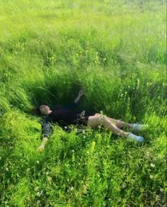 a woman laying in the middle of a field