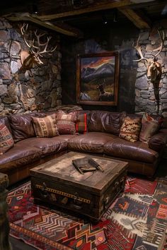 a living room filled with lots of furniture next to a wall mounted deer head on the wall