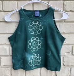 **We do each of these as a custom order, so each top is batiked and dyed to order. Please let us know what color you would like! Also note that these take multiple days to complete, and we will ship within 10 days of ordering.**These are SUPER stretchy! Wonderful for yoga, acro, pole, dance, etc. Slim fit designed for movement. Will not shift when you're inverted. 92% cotton, 8% stretch. Sewn with cotton thread.The flower pattern repeats up the center line, front and back.Made with a hand carved Flower Crop Top, Center Line, Diy Vetement, Hand Dyed Fabric, Pole Dance, Asheville Nc, Cotton Thread, Single Piece, Flower Pattern