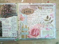 an open scrapbook with flowers and words on the pages, sitting on a wooden table