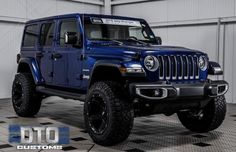 a blue jeep is parked in a garage