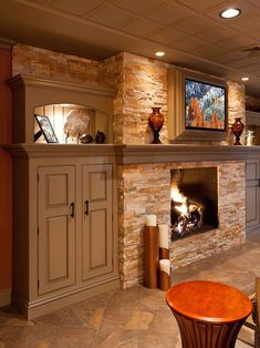 a living room filled with furniture and a fire place in the middle of a room