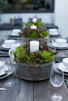 the table is set with candles and plates