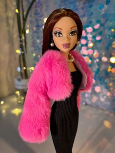 a barbie doll wearing a pink fur coat