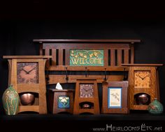 an assortment of wooden clocks and vases on a black surface with the words welcome above them