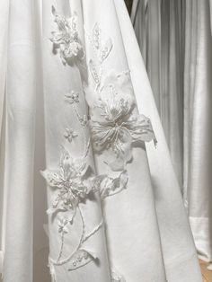 white curtains with embroidered flowers on them