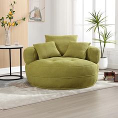 a living room filled with furniture and a large round chair in front of a window