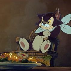 a cartoon cat sitting on top of a chair next to a plate of fruit and vegetables