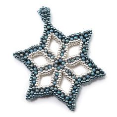 a beaded star ornament on a white background with blue beads and silver accents