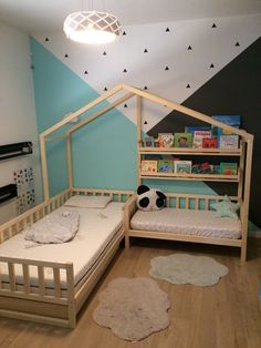 a child's bedroom with two beds and a book shelf in the corner,