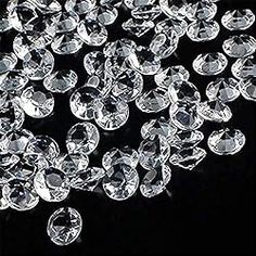 many clear crystal stones on a black background