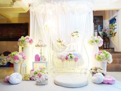 a white table topped with lots of flowers