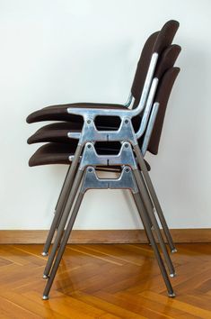 a stack of chairs sitting on top of a hard wood floor