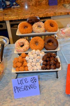 donuts and other pastries are on display at a buffet table with a sign that says life preservers