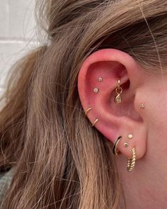 a close up of a person with ear piercings on their left and right sides