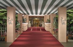 a red carpeted entrance way leading into a hotel