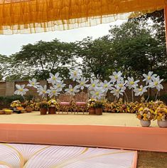 an outdoor ceremony setup with flowers and chairs