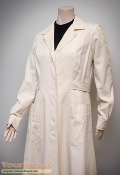 a mannequin wearing a white coat and black shirt