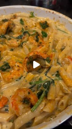 pasta with shrimp and spinach in a creamy sauce on the stove top, ready to be eaten