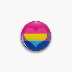 a button with a heart in the colors of the flag of colombia on it's side