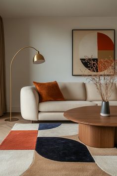 a living room with a couch, coffee table and art on the wall above it