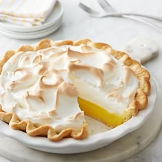 a lemon meringue pie on a white plate