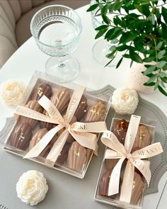 some chocolates are wrapped in ribbon and sitting on a table