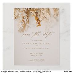 a white and gold wedding card with flowers on it