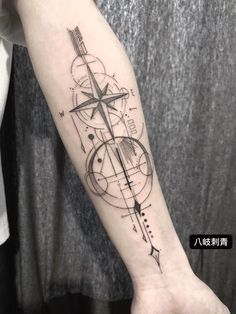 a person with a compass tattoo on their arm