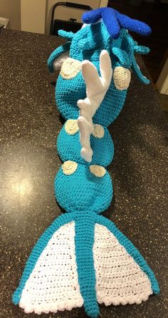 two crocheted stuffed animals sitting on top of a counter