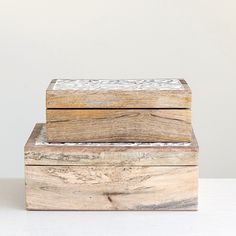 two wooden boxes sitting on top of each other