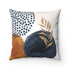 a decorative pillow with an orange and blue design on the front, along with polka dots