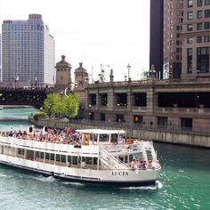 a large boat filled with people traveling down the river