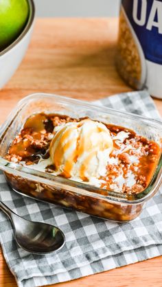 an apple dessert in a glass dish with ice cream on top