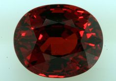 a red diamond sitting on top of a white surface