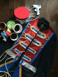 an assortment of crafting supplies laid out on top of a wooden floor next to scissors and thread