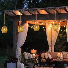 an outdoor living area with couches and lights