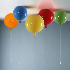 several balloons are suspended from the ceiling by strings