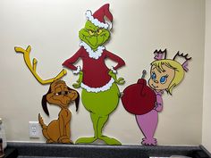 the grinch characters are hanging on the wall