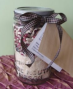 a jar filled with red beans and rice next to a cutting board on a table