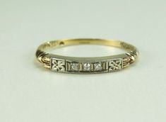 a yellow gold wedding band with five diamonds