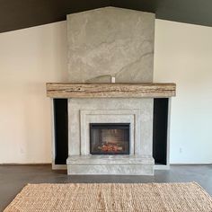 a living room with a fire place and rug on the floor